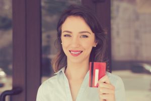 Smiling with a credit card