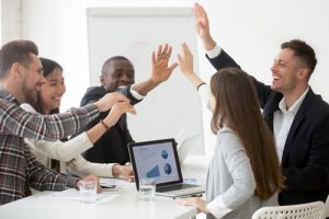 interracial team cheering with high five