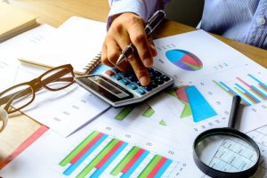 businessman working on Desk office, calculating Graph analysis