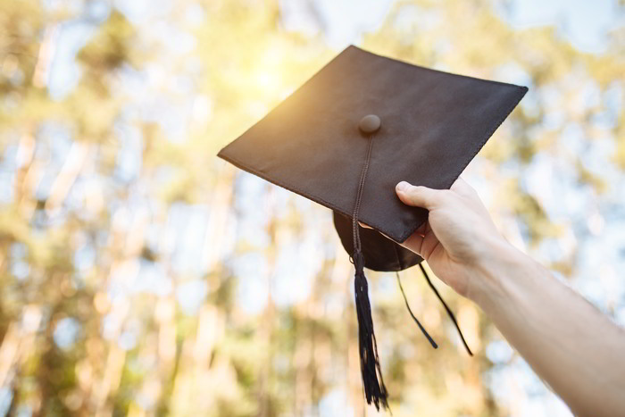 Man Holding Graduation Hat