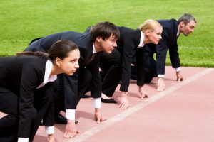 Confident business people lined up getting ready for race