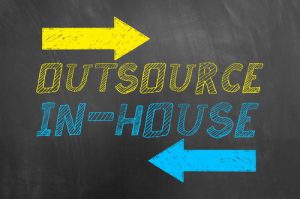 Outsource In House Text And Arrows On Blackboard