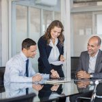 Smiling business team working together on a project in a modern conference room.