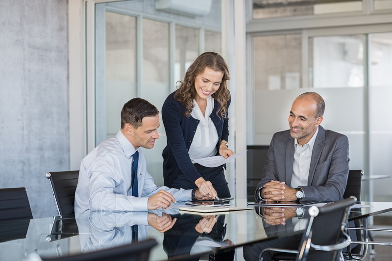 Smiling business team working together on a project in a modern conference room.