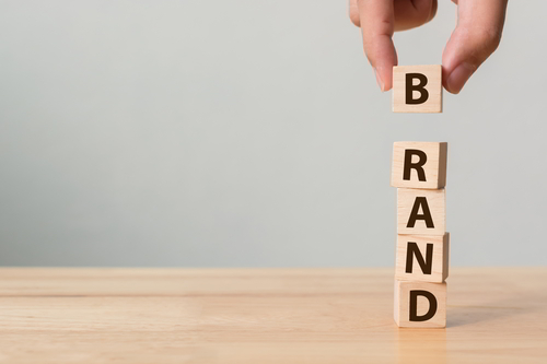 Wooden Dices Building A Tower Showing The Word BRAND